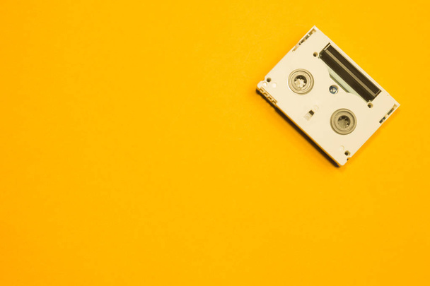 Digital video cassette on yellow background - Zdjęcie, obraz