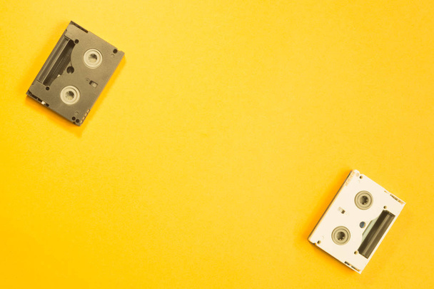 Digital video cassette on yellow background. mini dv cassette - Zdjęcie, obraz