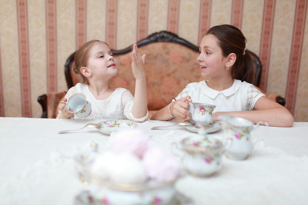 Beautiful little girls with tea - Foto, imagen