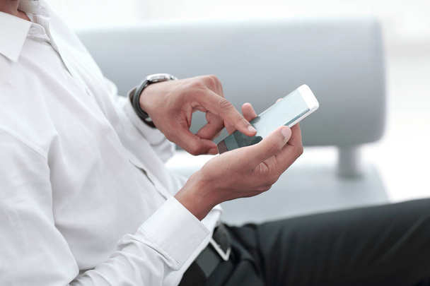 close up. modern man typing on his smartphone. - Foto, Bild