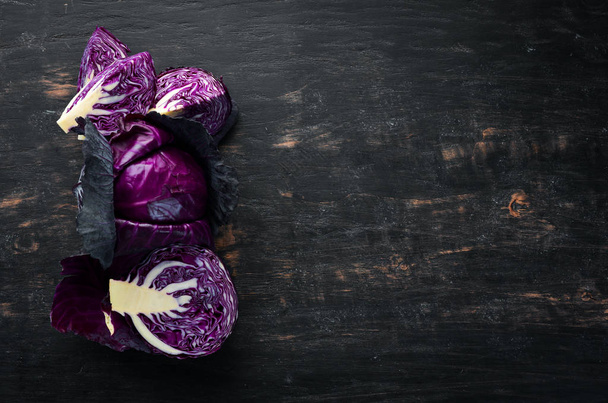Fresh cabbage. Purple cabbage on a black background. Organic food. Top view. Free space for your text. - Zdjęcie, obraz