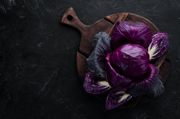 Fresh cabbage. Purple cabbage on a black background. Organic food. Top view. Free space for your text. - Φωτογραφία, εικόνα