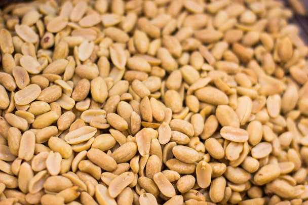 brushed peanut nuts food background on supermarket counter for selling  - Photo, Image