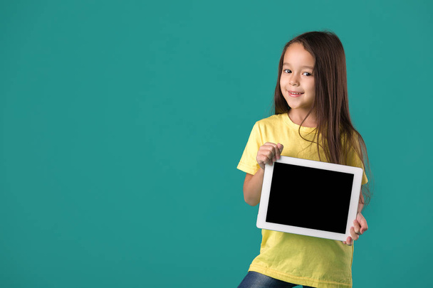 little girl holding a blank tablet computer - Fotó, kép