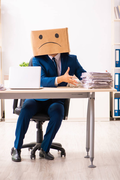 Unhappy man employee with box instead of his head  - Fotó, kép