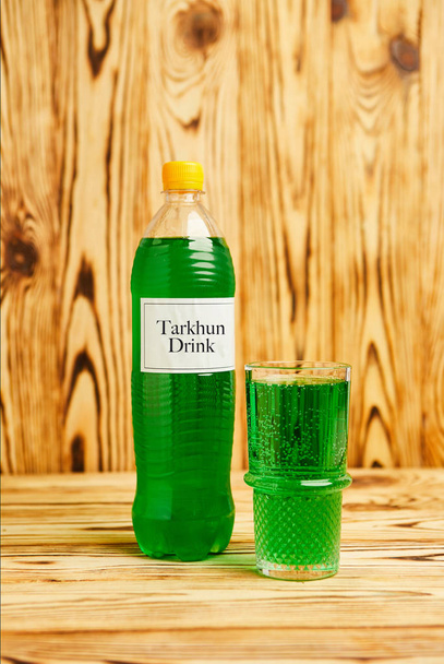 Glass full of sparking green tarkhun, homemade in Georgia, traditional drink, authentic recipe - Photo, Image