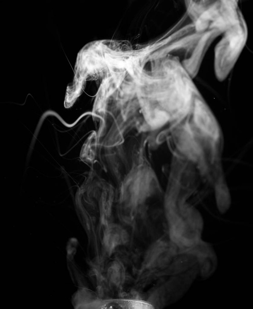 Vape smoke clouds isolated on black background. Hot vape liquid splash in vape coil. Nice aromatic cloud. Low light black and white monochrome photo. Underexposed photo in a low key style.  - Fotó, kép