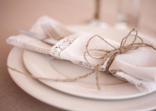 Elegant restaurant table setting for fine dining with plates cutlery and stemware - Фото, зображення