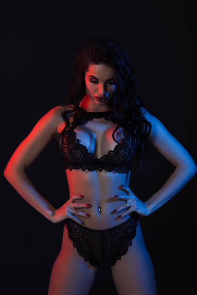 Sexy woman in lace black sensual lingerie with long curly hair - 写真・画像