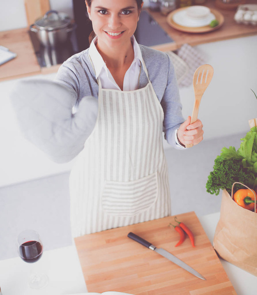 Woman making healthy food standing smiling in kitchen - Photo, image