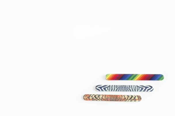 Multicolored used pedicure manicure nail files on white isolated background - Photo, Image
