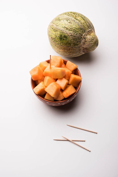 Cantaloupe / muskmelon / kharbuja cut into pieces, served in a bowl. selective focus - Photo, Image