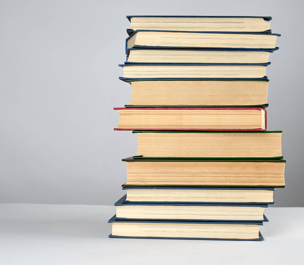 stack of different books on a gray background - Foto, Bild
