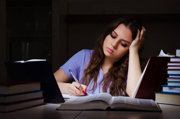 Young female student preparing for exams late at home  - Photo, Image