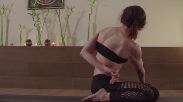 Young woman practicing yoga - Ardha Padmasana, Twist - Felvétel, videó