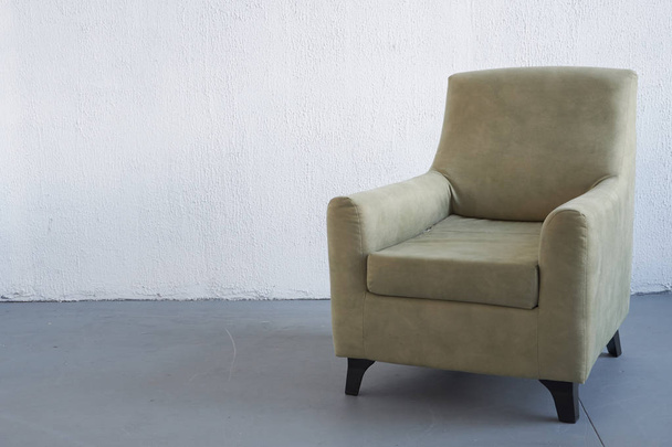Old vintage armchair by the white wall. place for text. donation, poverty minimalism, give life to the old - Photo, image