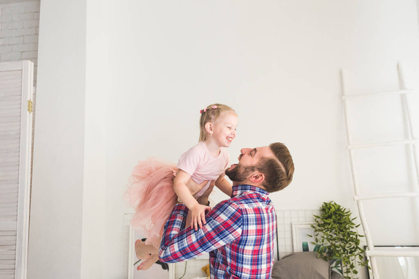 Cute little girl and her dad are having fun at home. - 写真・画像