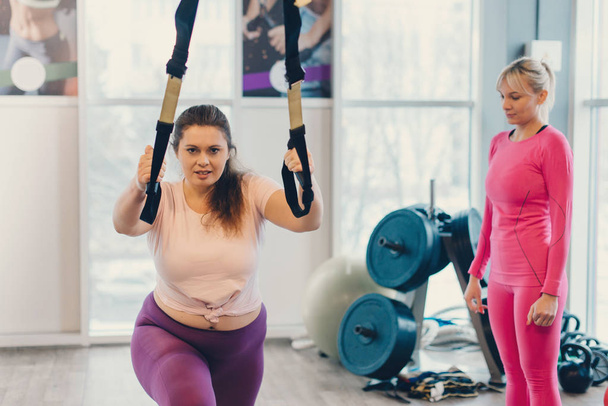 Fat woman works out in gym to lose weight - Valokuva, kuva