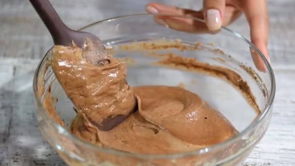 Mixing batter on kitchen. Adding melted butter to the chocolate batter. - Footage, Video