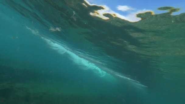 Slow Motion onderwater: krachtig schuimende buis Golf waardoor zijn weg naar de kust raken van de camera kloppen het niet op zijn plaats. Potentieel gevaarlijke, maar mooie tongolf toont zijn destructieve krachten - Video