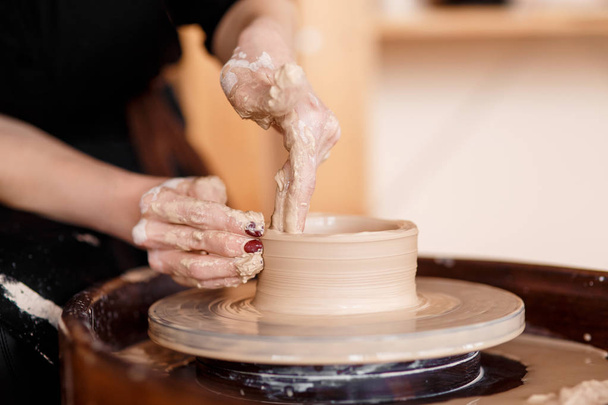 Hands sculpt new utensil on a pottery wheel - Photo, Image