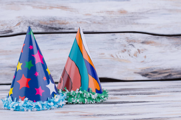 Two Birthday hats on wooden background. - Photo, Image