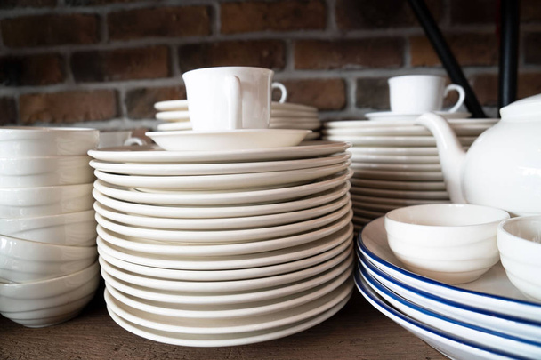 Many white plates are stacked together.a stack of white dish . - Photo, Image