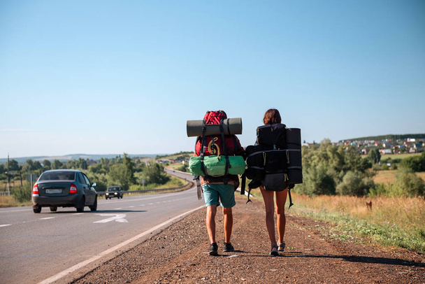 Travel man hitchhiking. Backpacker on road - Photo, Image