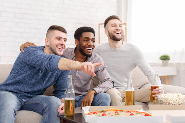Look. Man pointing on tv, watching soccer with friends - Foto, Imagem