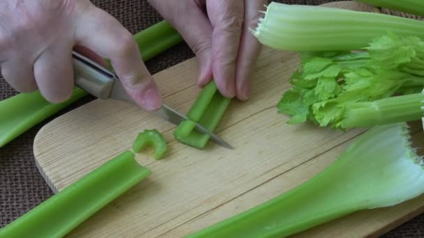Sliced fresh celery on a cutting wooden board. Healthy food.  - Footage, Video