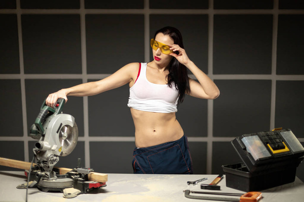 DIY Craftsman women dressed in white shirt and orange goggles in - Photo, Image