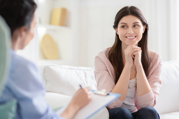 Smiling woman talking to wellness coach about motivation - Photo, Image