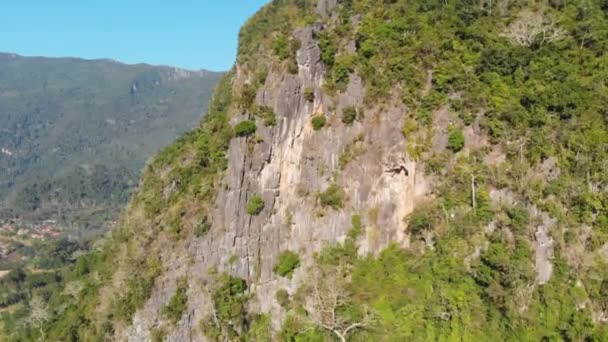Aerial: drone flying over natural rainforest green jungle populating steep valley cliffs in the mountains of North Laos, travel destination in South East Asia. - Footage, Video