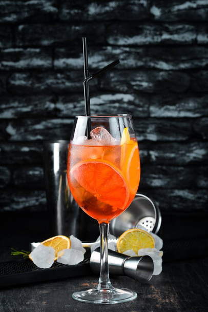 Cocktail Aperol Sprits. Alcoholic cocktail. On a wooden background. Top view. Free copy space. - Фото, зображення