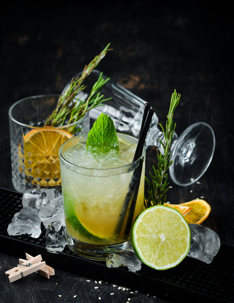 Caipirini with Rom. Alcoholic cocktail in a glass. On a wooden background. Top view. Free copy space. - 写真・画像