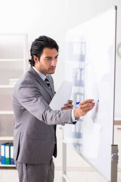Young handsome businessman in front of whiteboard  - Foto, Imagem