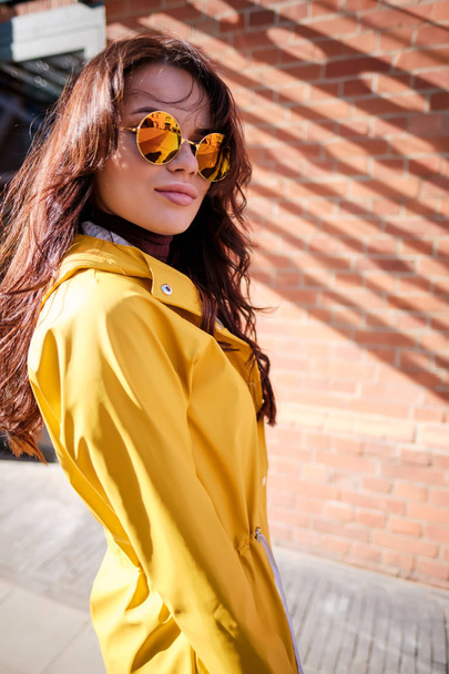 Female fashion concept. Close up. Colorful detail of yellow coat - Fotó, kép