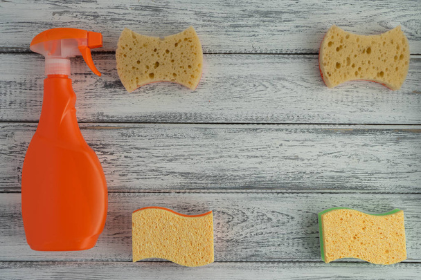 Universal cleaning spray and sponges on light background. Household concept, detergent - 写真・画像