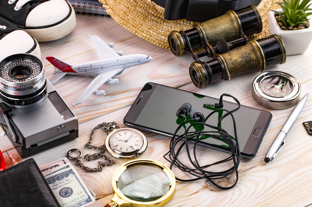 items and accessories for the traveler on the old background on the table - Foto, Bild