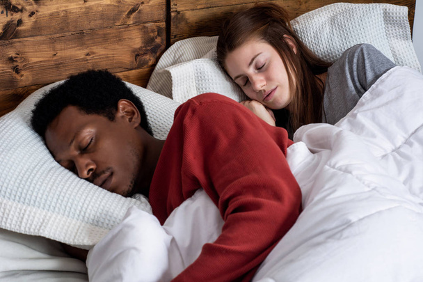 Young couple sleeping in a bed. - Fotoğraf, Görsel