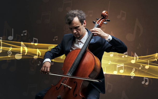 Musicien jouant sur violoncelle avec des notes autour
 - Photo, image