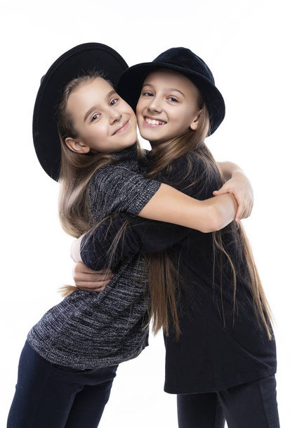 Two cute teenage girlfriends schoolgirls wearing turtleneck swea - Fotoğraf, Görsel
