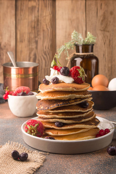 Delicious, only cooked sweet pancakes with frozen berries on a white plate. American traditional dish. High calorie and nutritious breakfast. - Photo, Image