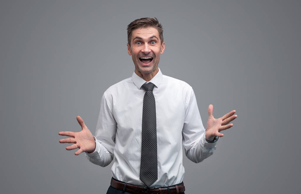 Excited businessman looking at camera - Photo, image