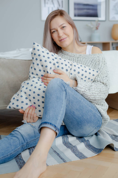 A blonde woman in a cozy interior - Photo, image