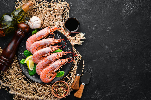 Great Royal Shrimps in a plate. Tiger prawns. Top view. Free space for your text. On the old background - Photo, image