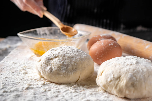 White flour with eggs, butter and dough on a cooking board - Fotoğraf, Görsel