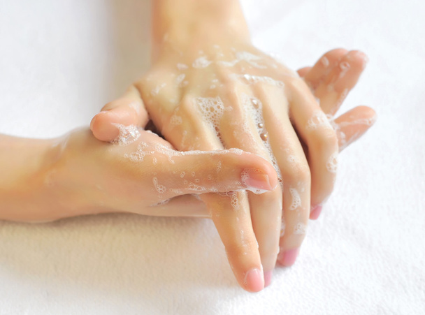 Washing woman hands on a background a white towel - Foto, imagen