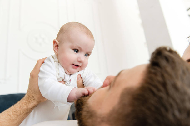 Young father hold and look at baby - Photo, image