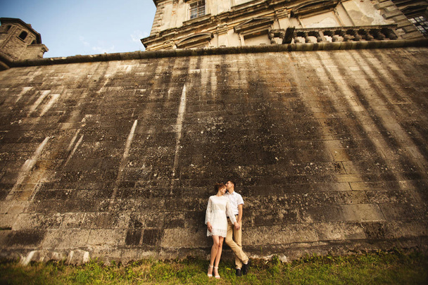 Charming and fashionable couple in love background old vintage castle - Photo, Image